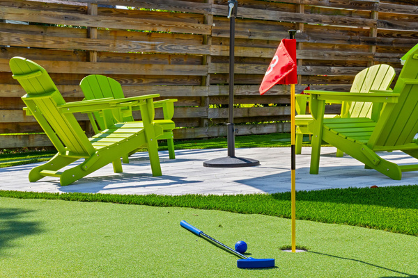 Hole 3 is a wrap! Finish your putting tournament right alongside the comfortable outdoor patio lounge. Complete with provided clubs and balls, our backyard setup makes it easy to jump from playing to relaxing.