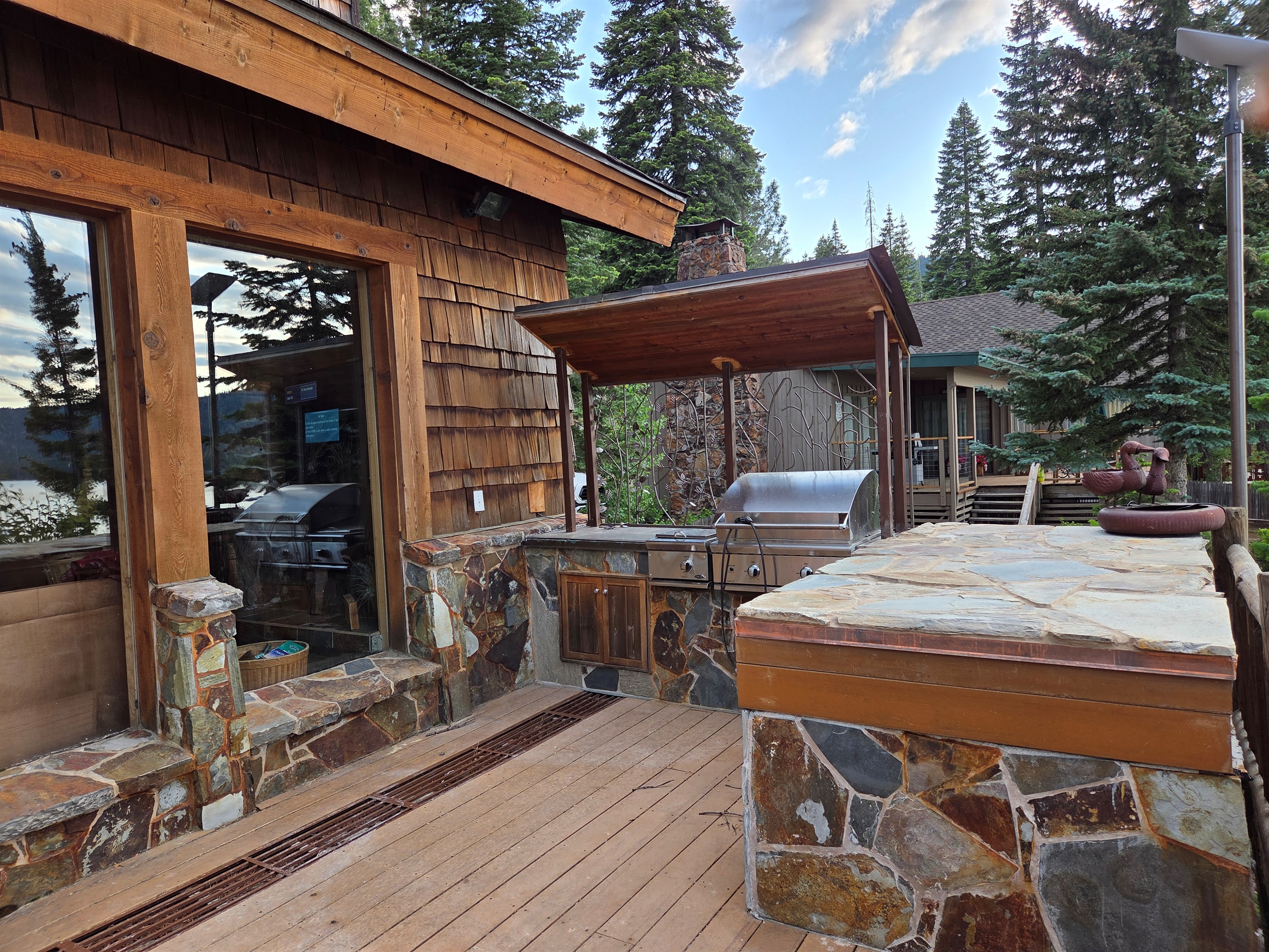 View from the deck to the side of the cabin.  Looking left when on the deck facing the lake.  We unfortunately are not allowed to have renters use our bbq.  So, the BBQ will be locked.