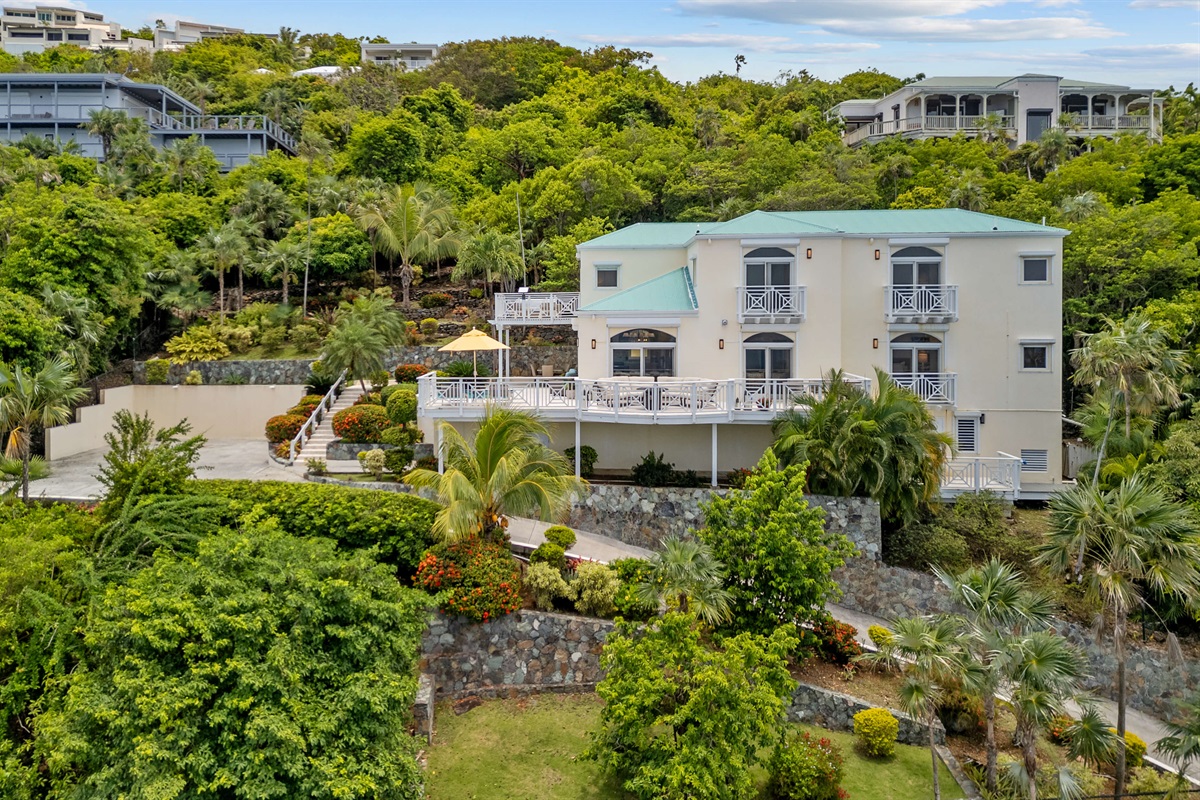 Tropical landscaping, lush plants, and walkways that make even coming home feel like a vacation.