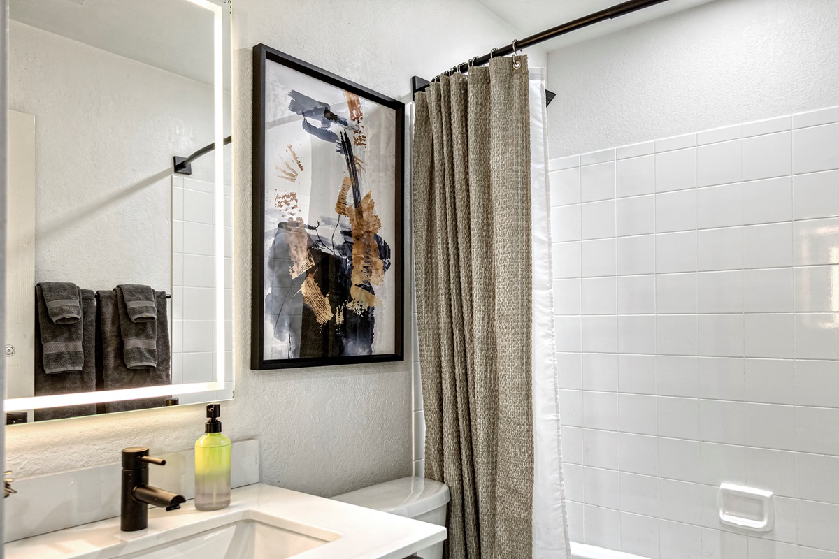 well-designed space offers a bright, refreshing atmosphere with a sleek vanity, ample lighting, and contemporary finishes that make daily routines easy and convenient.