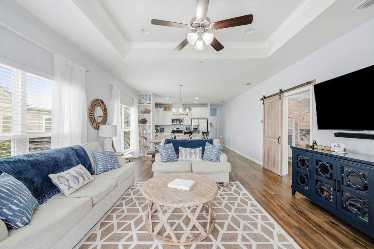 Unwind after a day at the beach in this bright, welcoming living room featuring plush seating, Smart TV, and plenty of space for family movie nights or relaxing together.