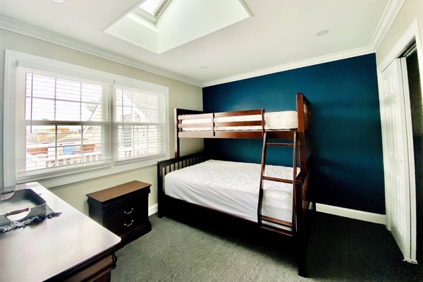 Upstairs bedroom with Full and Twin bunk beds. Skylights and large windows provide lots of natural light.