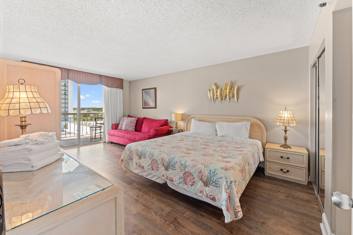 Spacious Main bedroom with King bed, balcony access, ensuite and a sofa bed.