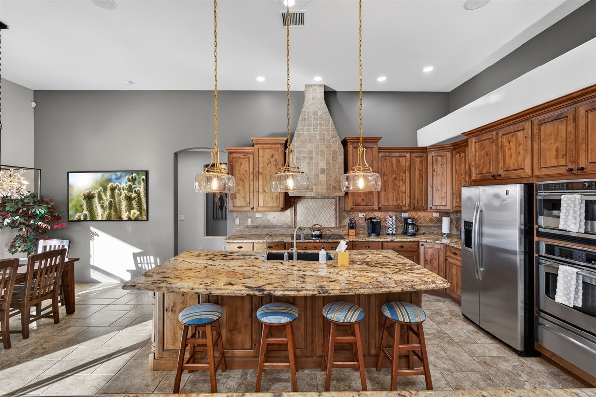 Expansive gourmet kitchen with bar seating and cooking essentials — ideal for groups, families, and celebrations