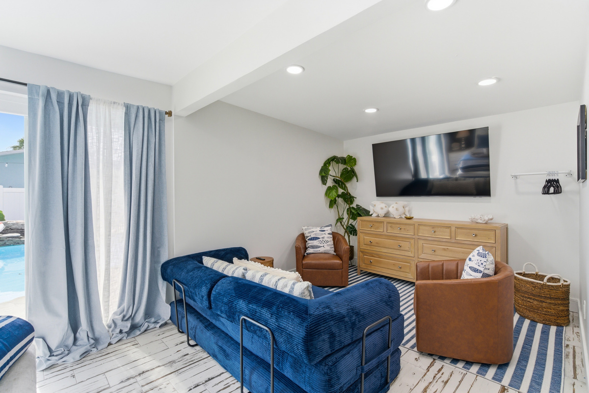 Other end of the Master bedroom features a pull out sleeper sofa and large Smart TV.