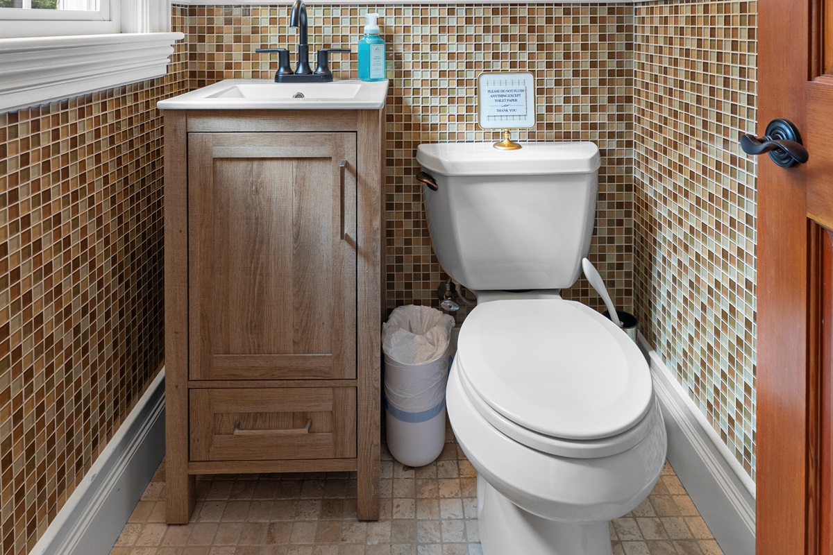 A warm and welcoming ensuite half bathroom, just right for quick moments of relaxation.