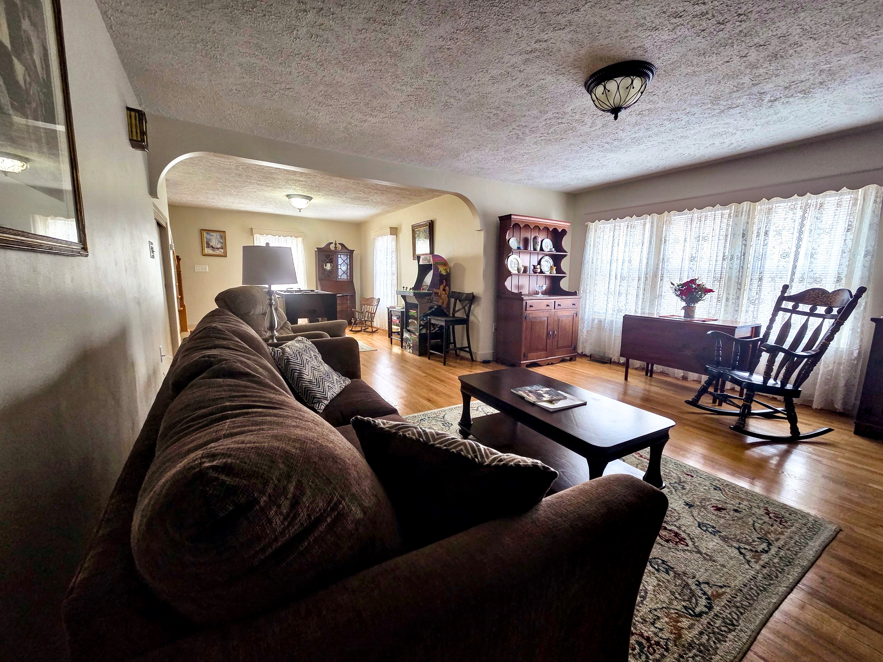 Open-concept sitting room with a dedicated game area.