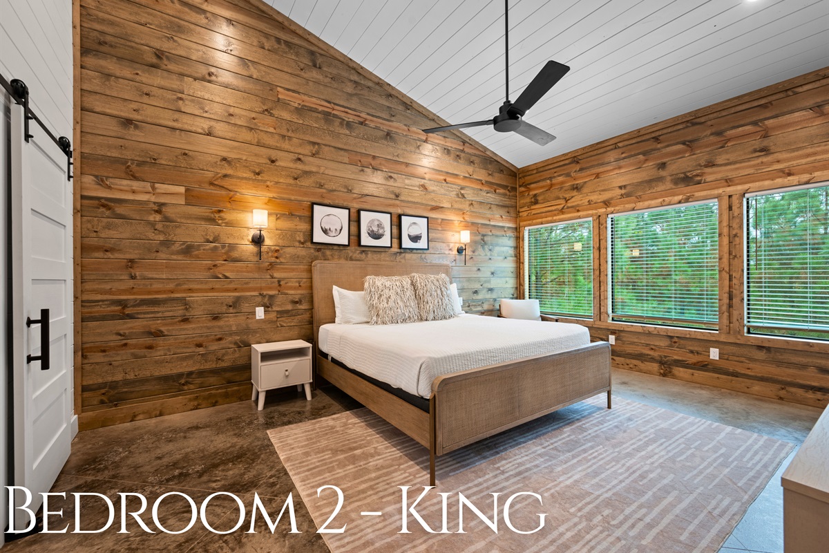 Bedroom 2: King bed with plenty of space and forest views.