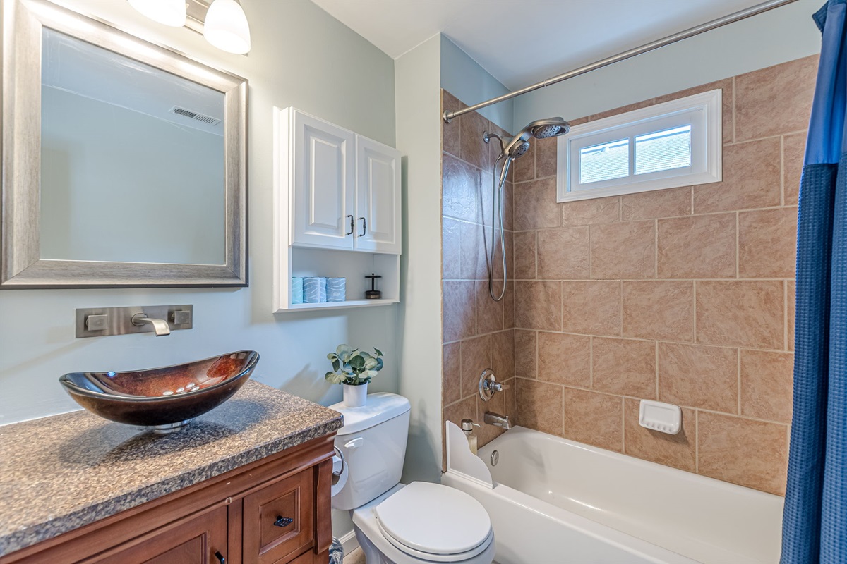Full upstairs bathroom with a tub/shower combo and a large, modern showerhead.