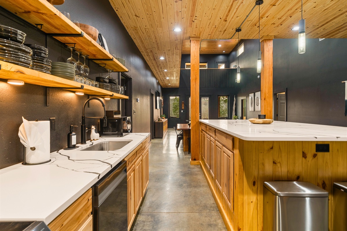 The long island offers plenty of seating, making it the perfect spot for morning coffee, casual meals, or chatting with the cook while dinner comes together.