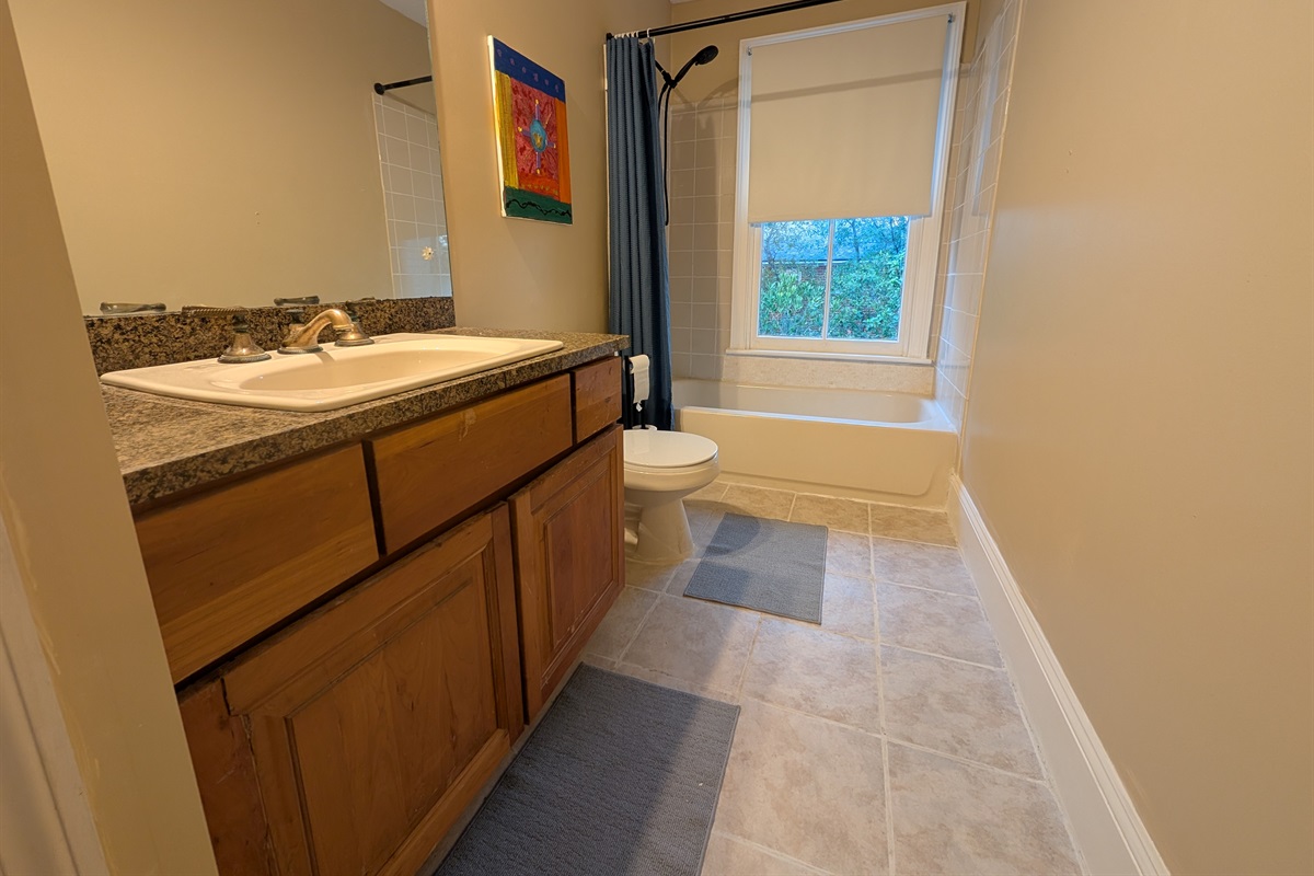 Full guest bathroom upstairs with tub and shower
