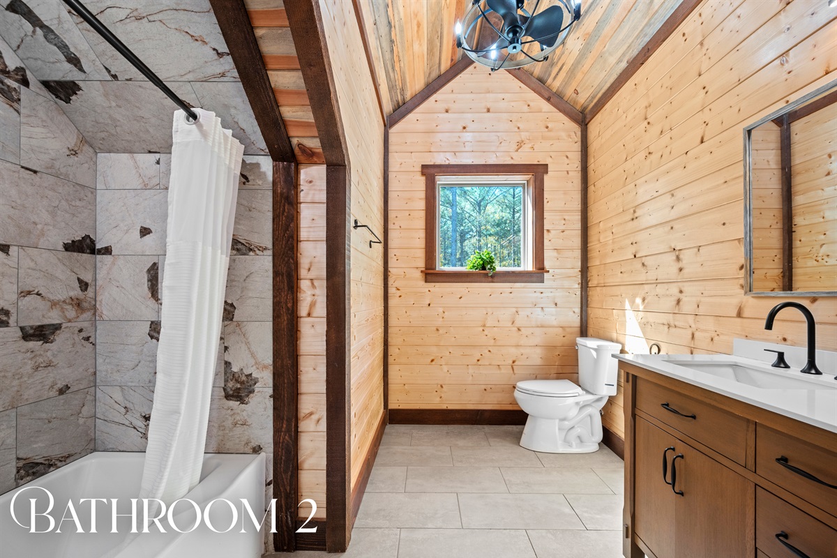 Full bathroom with shower and modern rustic touches.