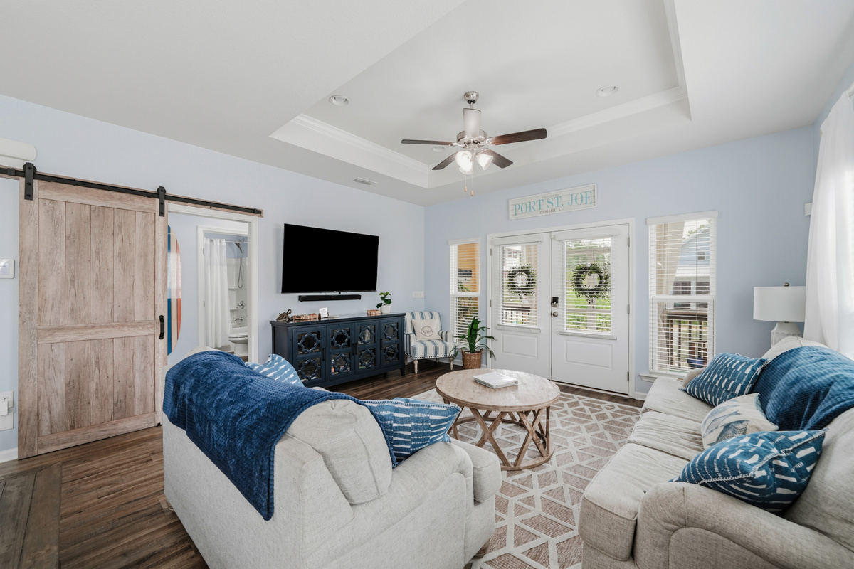 Relax in comfort. Bright and inviting living room with plush seating, perfect for movie nights or gathering with family and friends