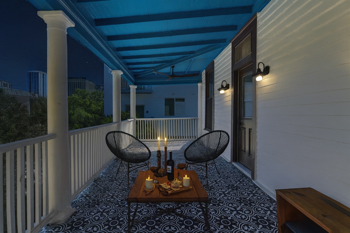 sitting on patio overlooking downtown austin with a glass of wine