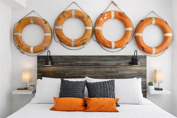 Titanic Primary Suite (Main Floor – Only Bedroom on Main Level): Nautical life-ring feature wall, king bed, and private ensuite bath.