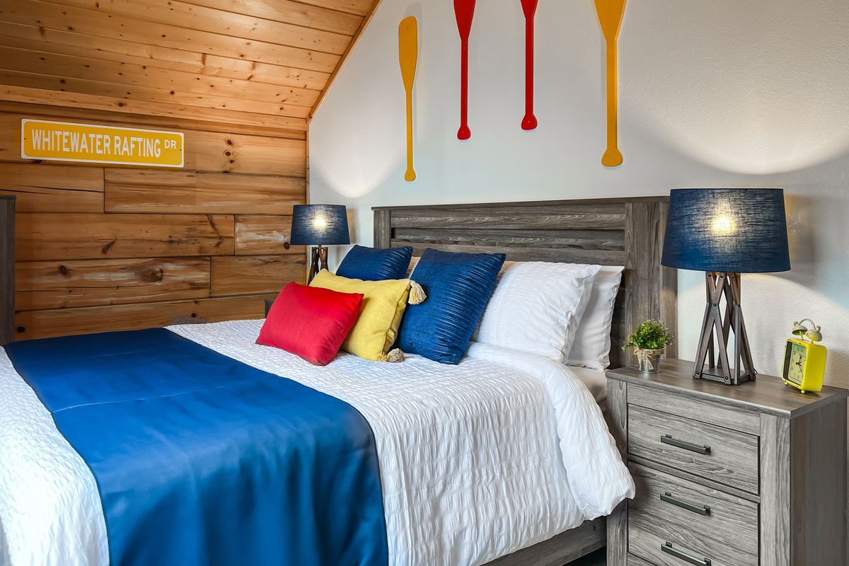 Another view of the second-floor Paddle Room, offering a comfortable king bed and relaxed mountain-cabin feel.