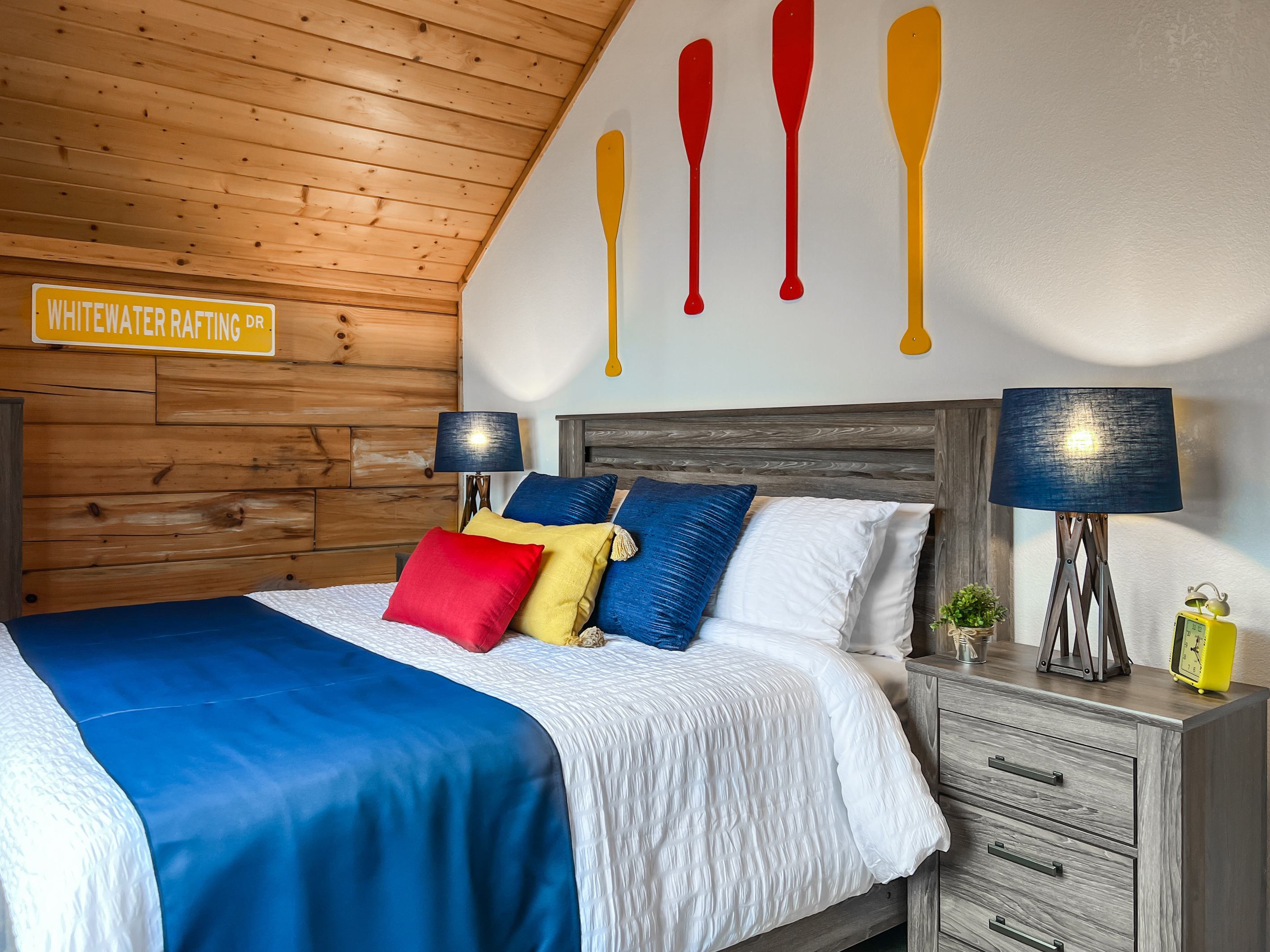 Another view of the second-floor Paddle Room, offering a comfortable king bed and relaxed mountain-cabin feel.