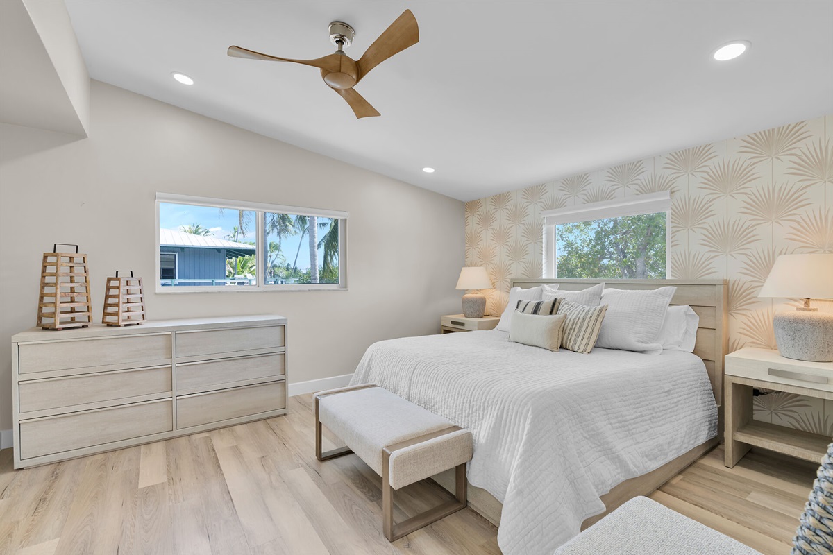 Primary bedroom with king bed, ensuite bathroom, walk-in closet with laundry.