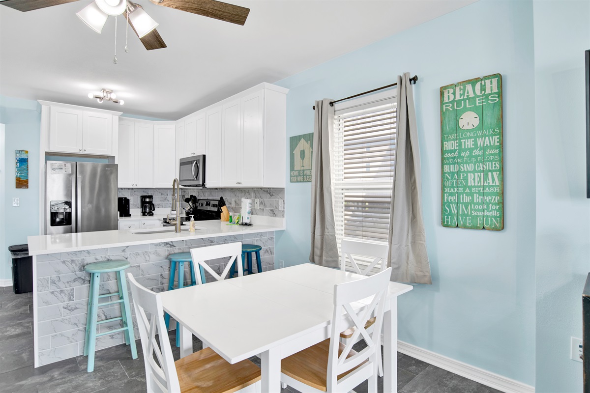 Dining area with seating for 4 at the table and 3 at the bar