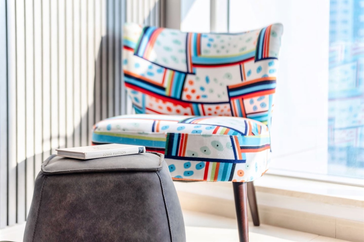 Enjoy a peaceful moment with a book  in this cozy corner in the living room.