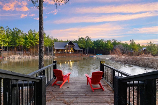 A breathtaking cabin entrance with grand wooden stairs leading to a luxury lodge surrounded by tall pine trees. This serene escape is perfect for nature lovers and outdoor enthusiasts.