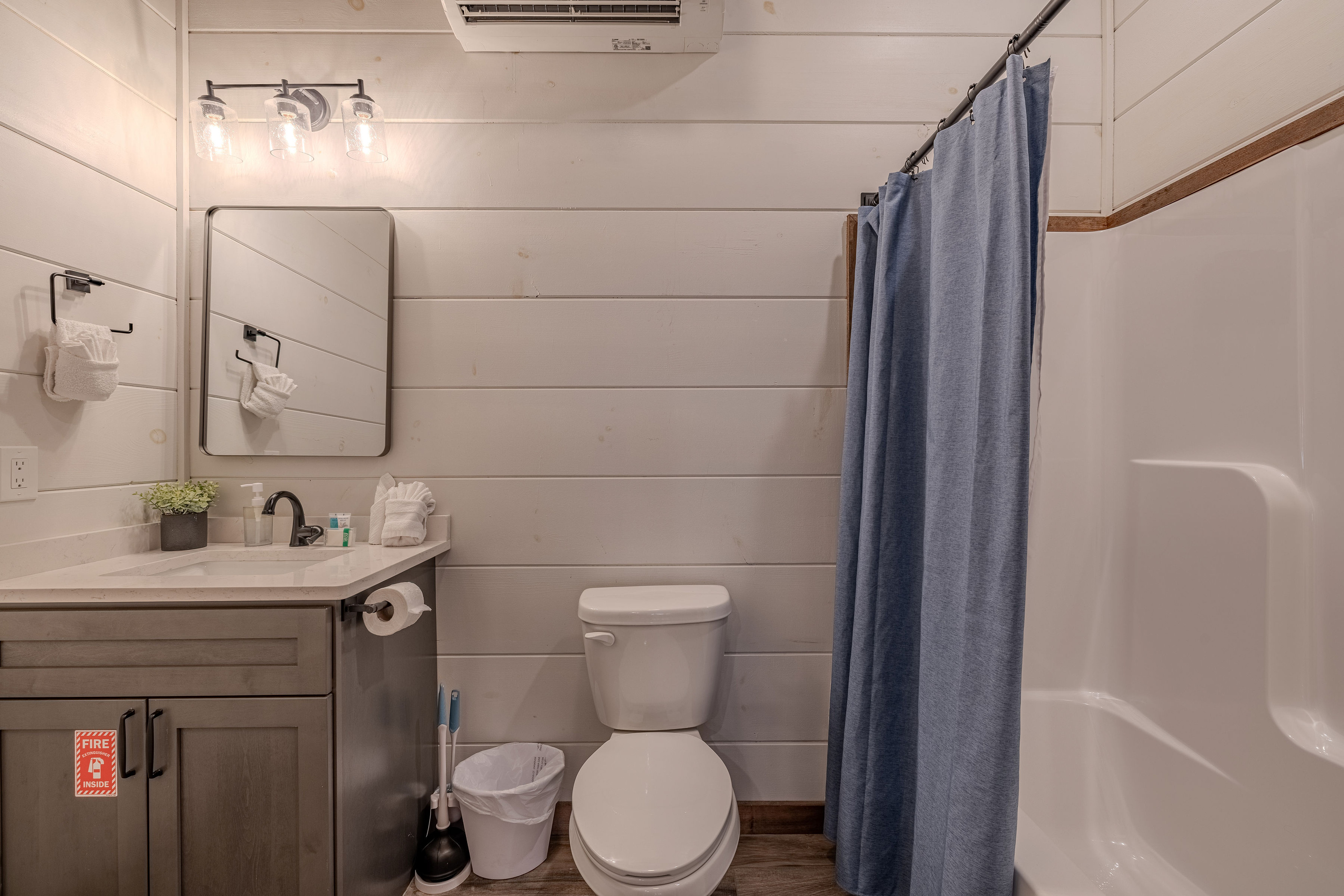 Full bathroom in lower level nearest the pool room also offers a bathtub.