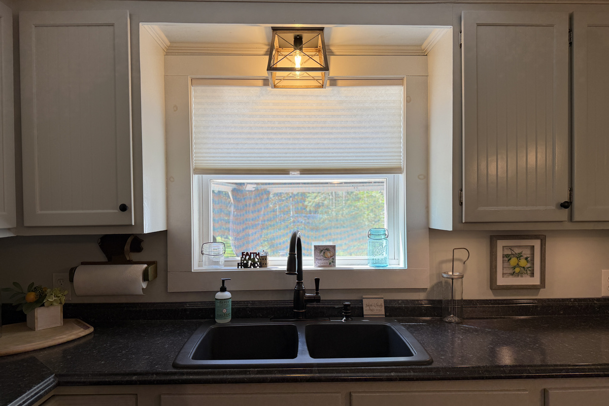 Kitchen sink overlooking back deck and yard