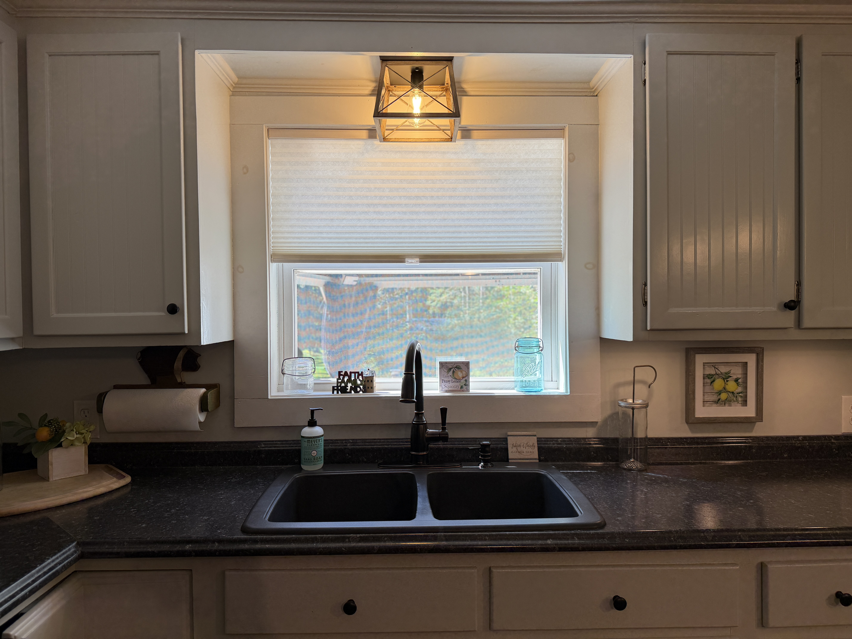 Kitchen sink overlooking back deck and yard