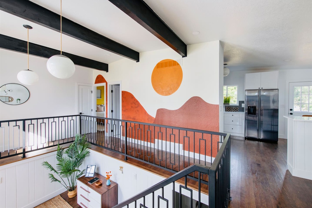 Retro inspired split level style entry with artistic mural and tons of natural light.