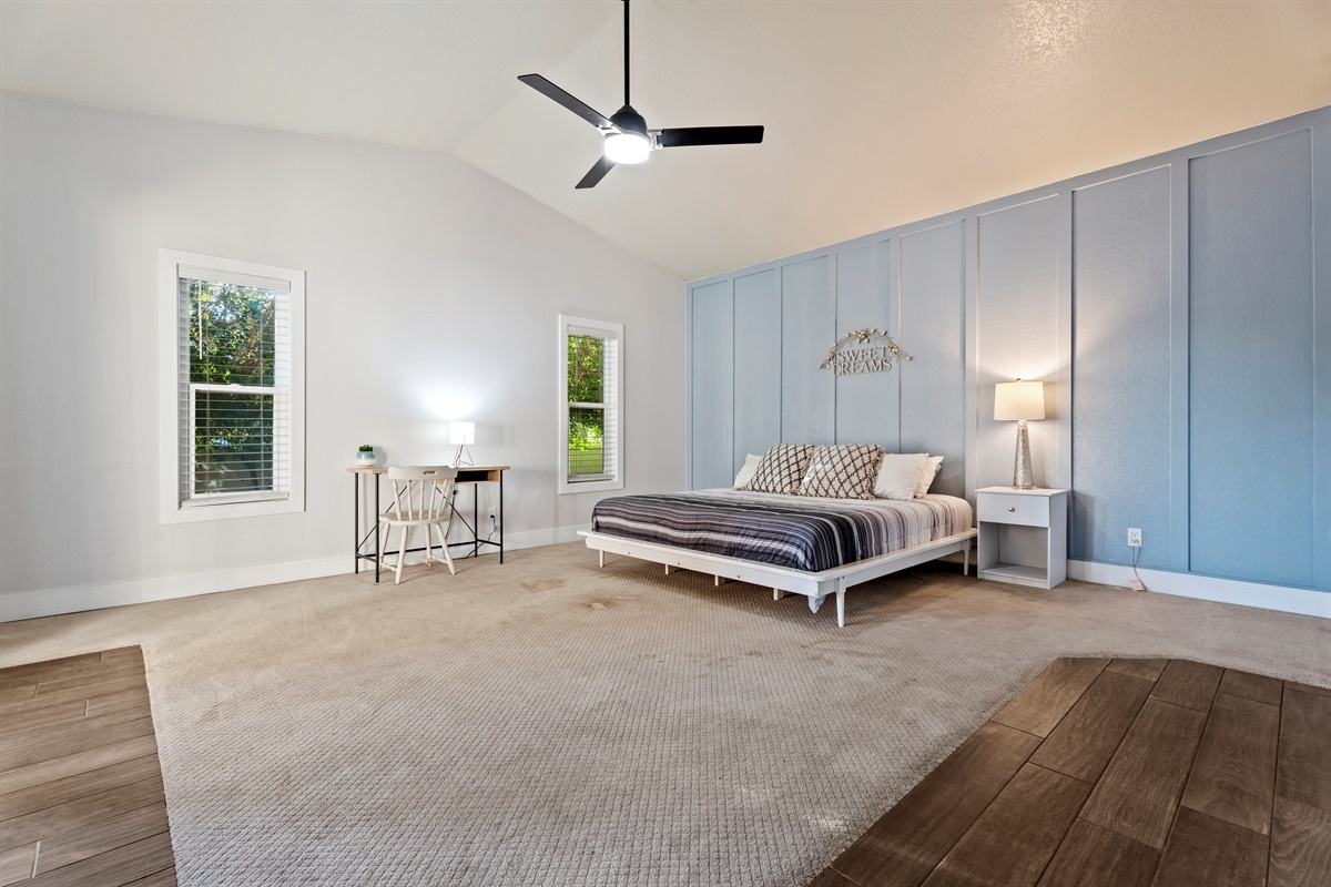 Unwind in the spacious primary bedroom with a king bed, dedicated workspace, and extra room for a Pack ‘n Play or lounge area.