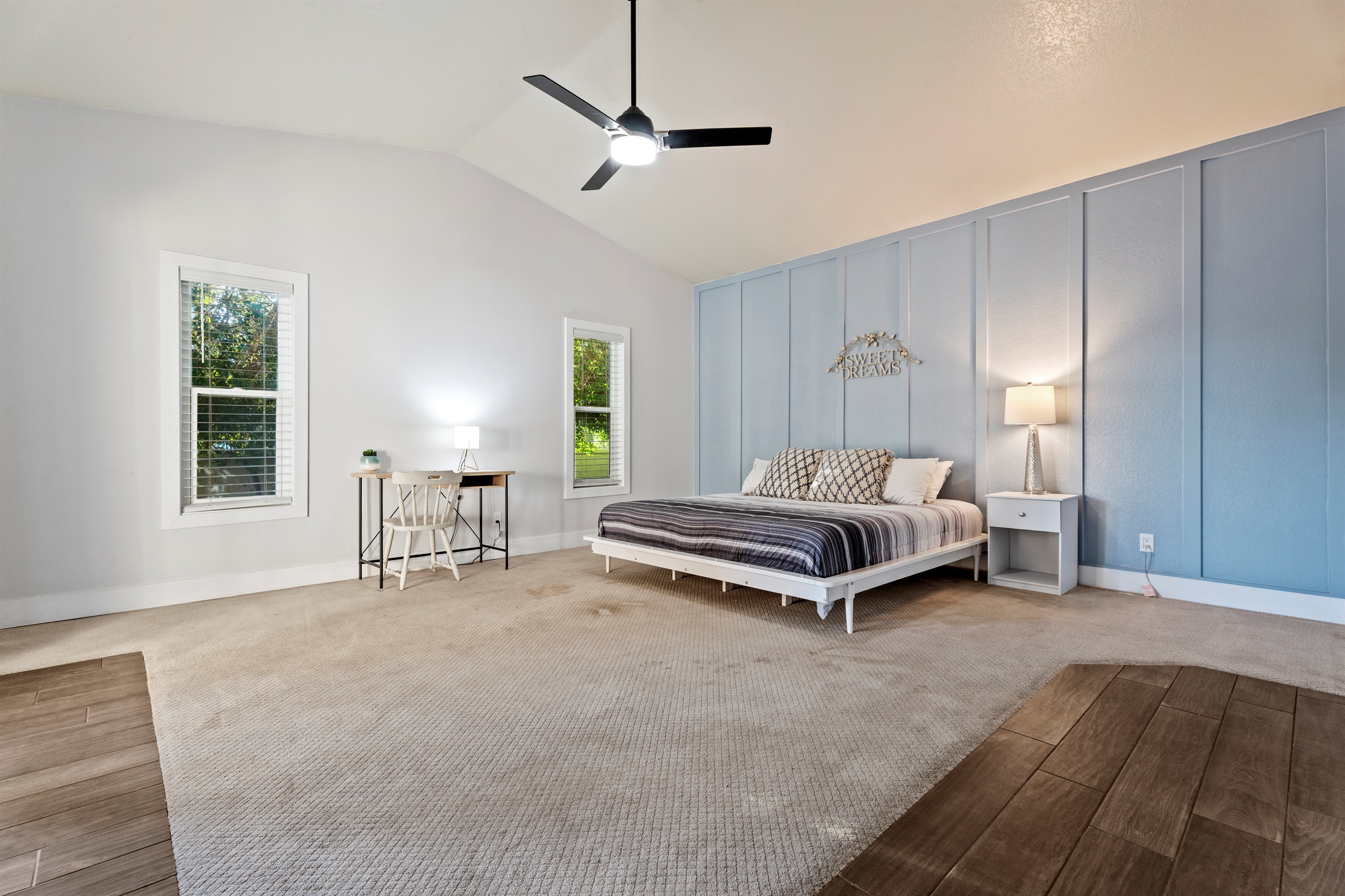 Unwind in the spacious primary bedroom with a king bed, dedicated workspace, and extra room for a Pack ‘n Play or lounge area.