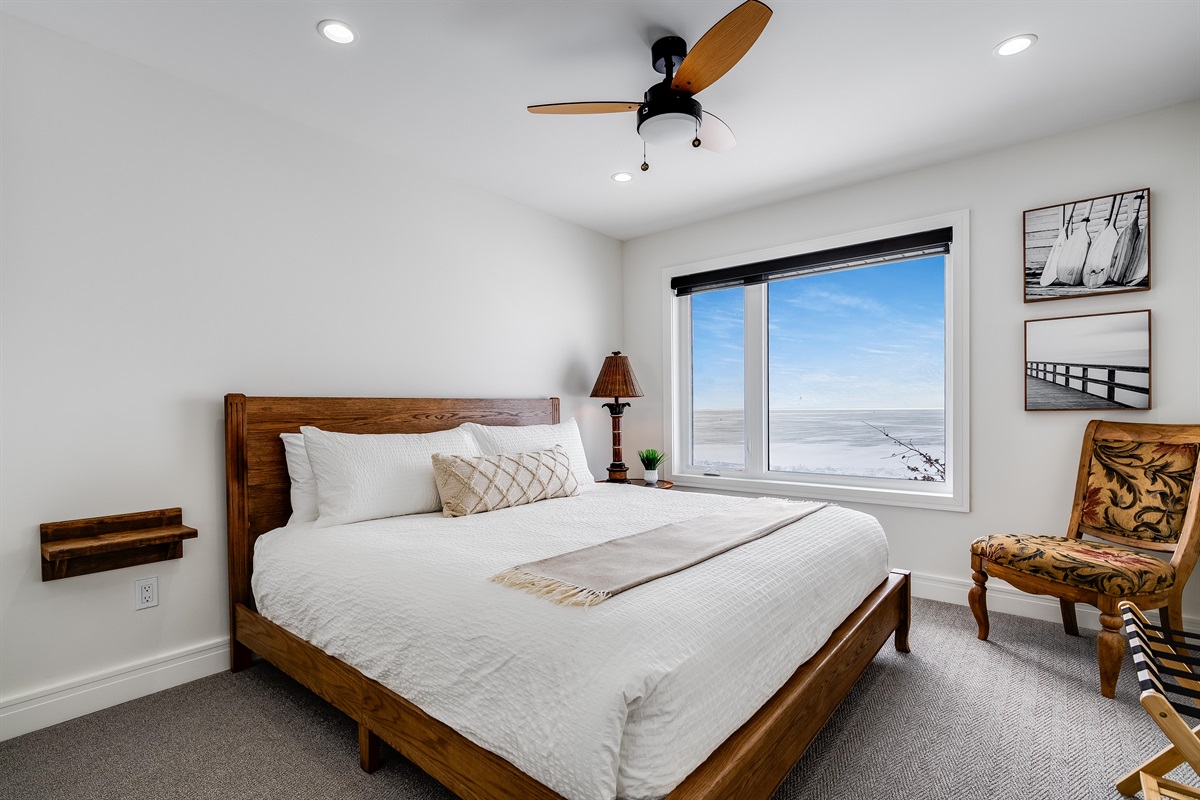 A King Bedroom with Natural wood bed frame grounds the space.