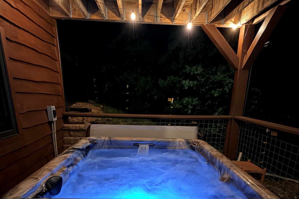 Hot tub with a lounger and two bench seats. 