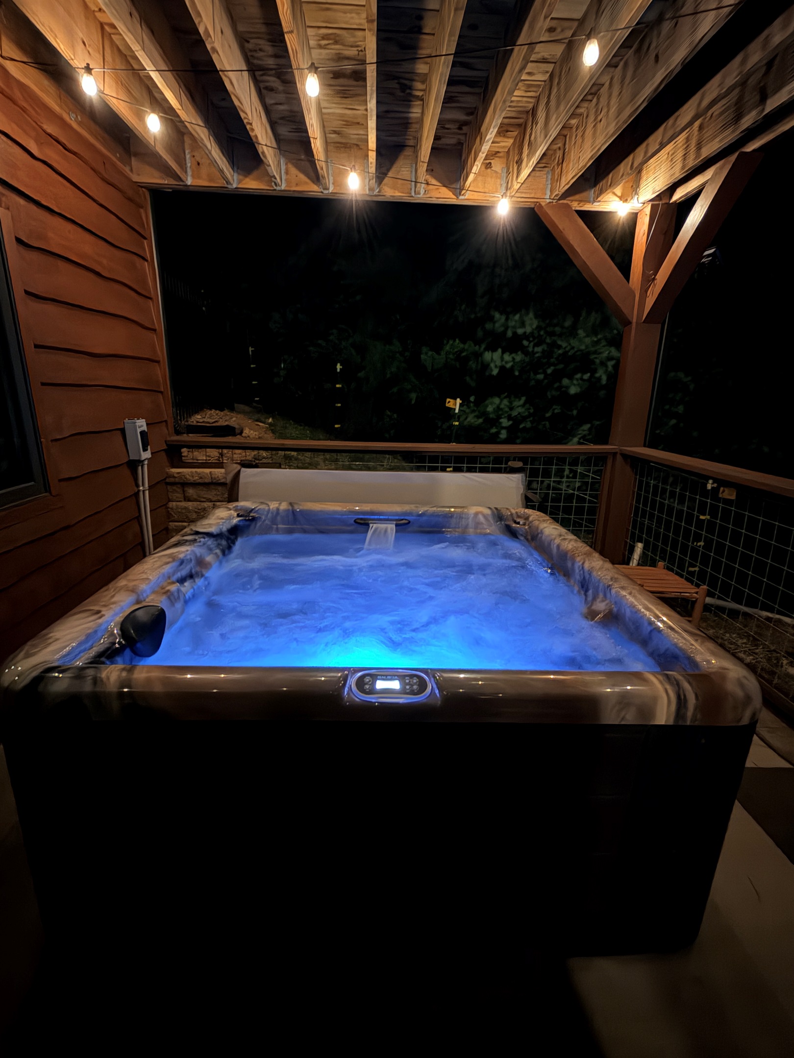 Hot tub with a lounger and two bench seats. 