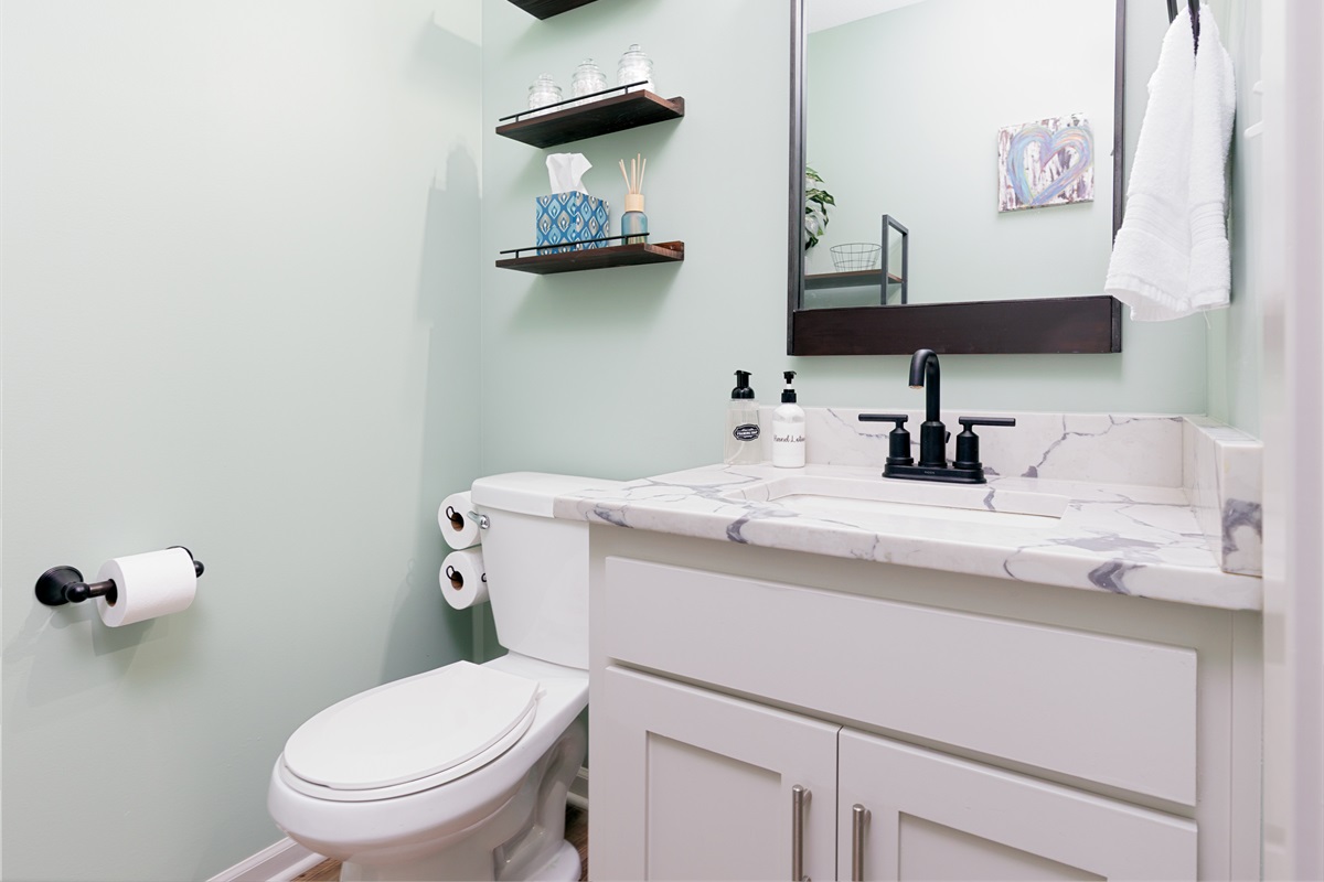 Convenient half bath located just off the main living area for added comfort and accessibility.