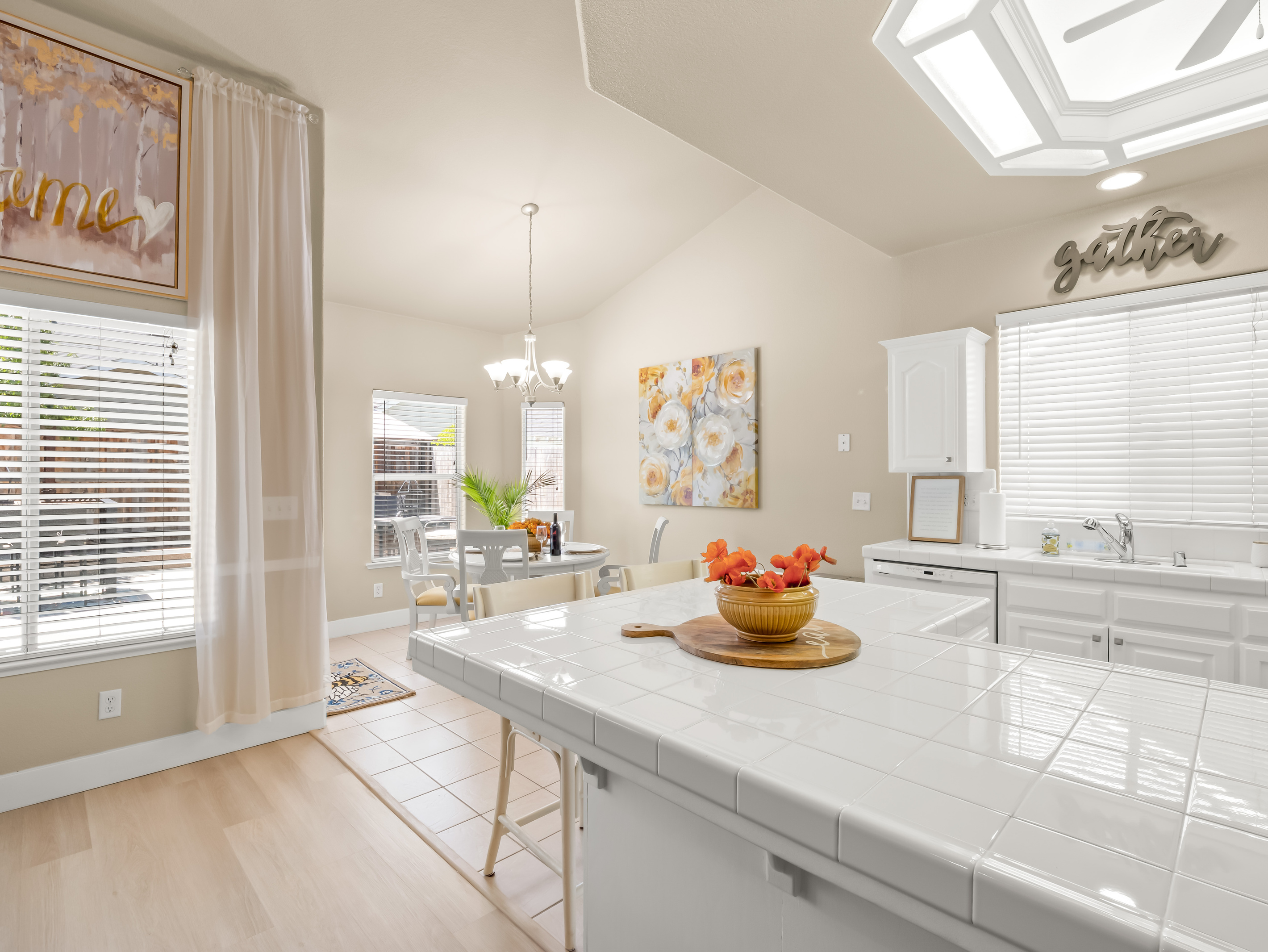 The bright and airy kitchen flows seamlessly into the dining area, creating the perfect space for sharing meals, conversations, and quality time together.