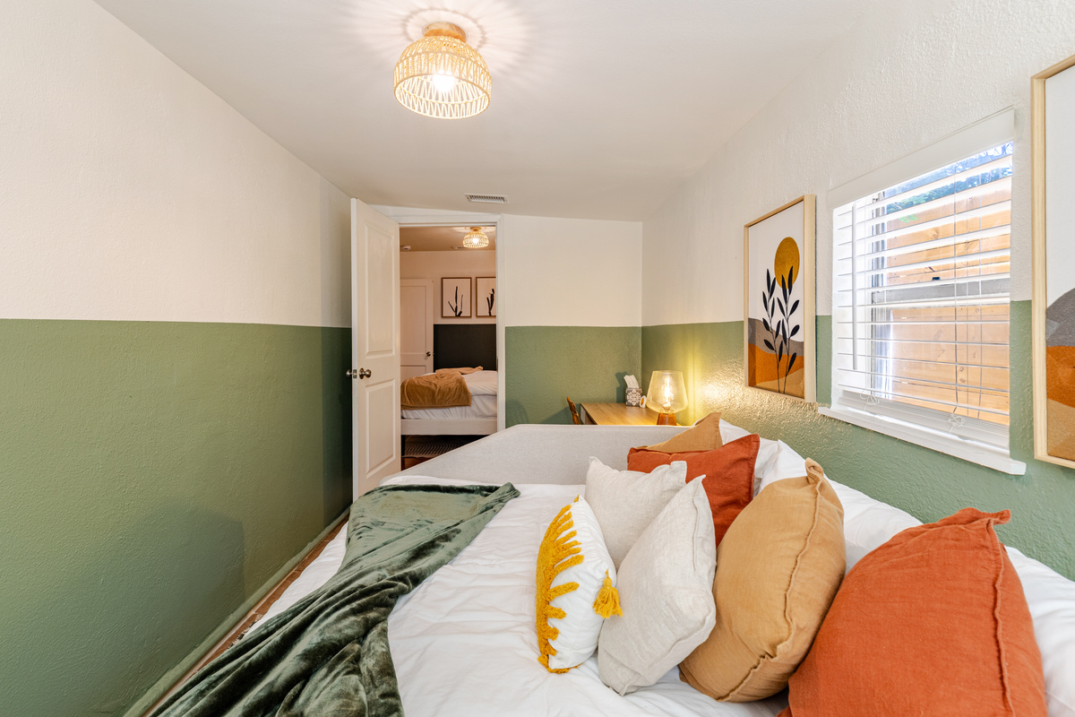 Stylish room with vibrant decor and warm lighting for a peaceful stay!