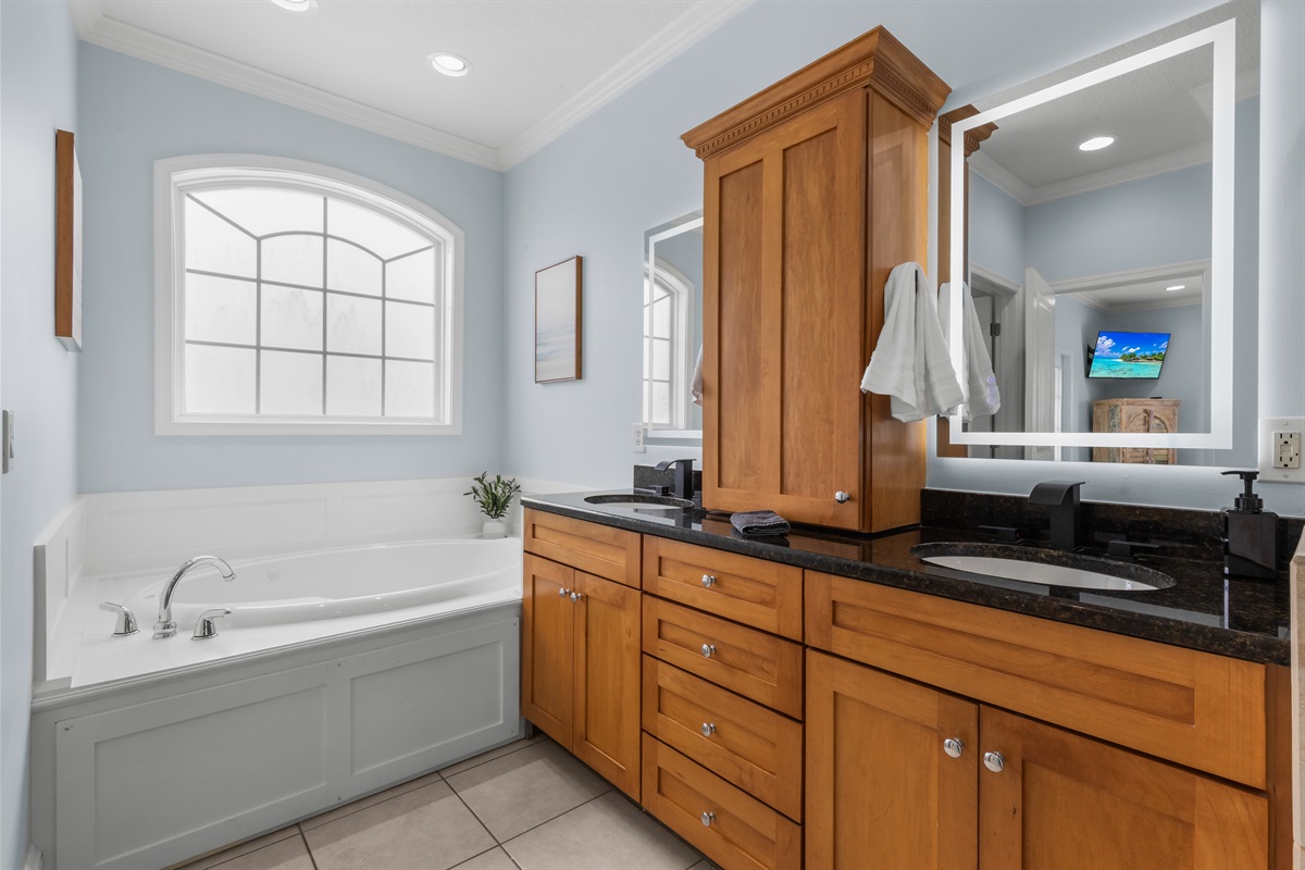 Soak your cares away in the jetted tub in the primary suite bathroom on the main level