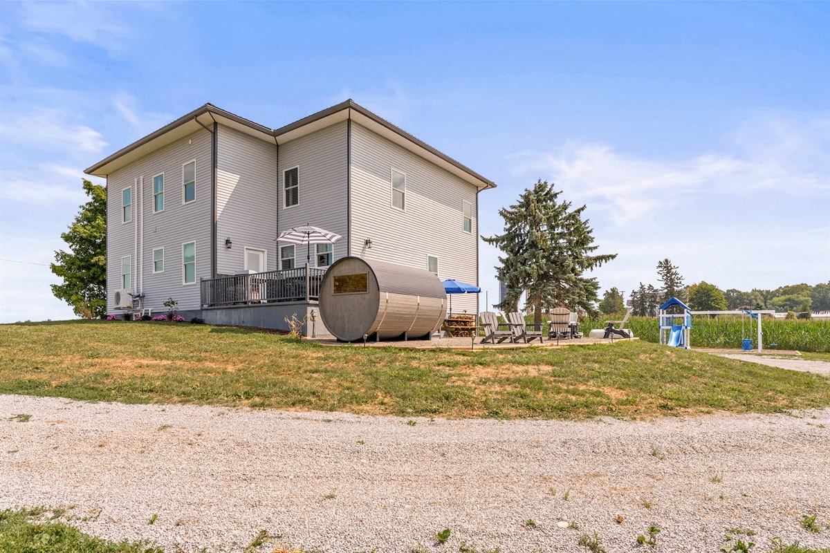Unwind in style with a private deck, outdoor seating, fire pit and a unique barrel sauna overlooking the scenic countryside.