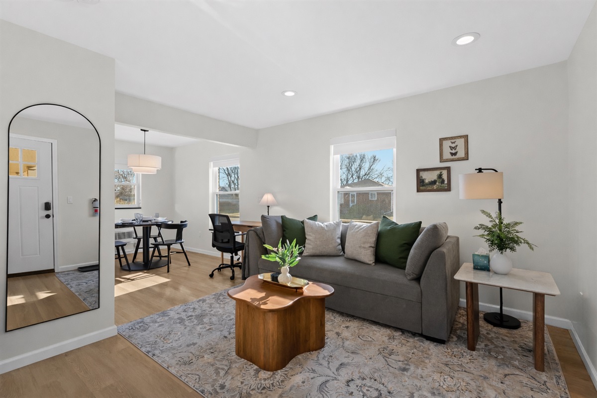 Bright, open living space with stylish seating, cozy accents, and natural light—perfect for relaxing, working remotely, or unwinding after a day out.