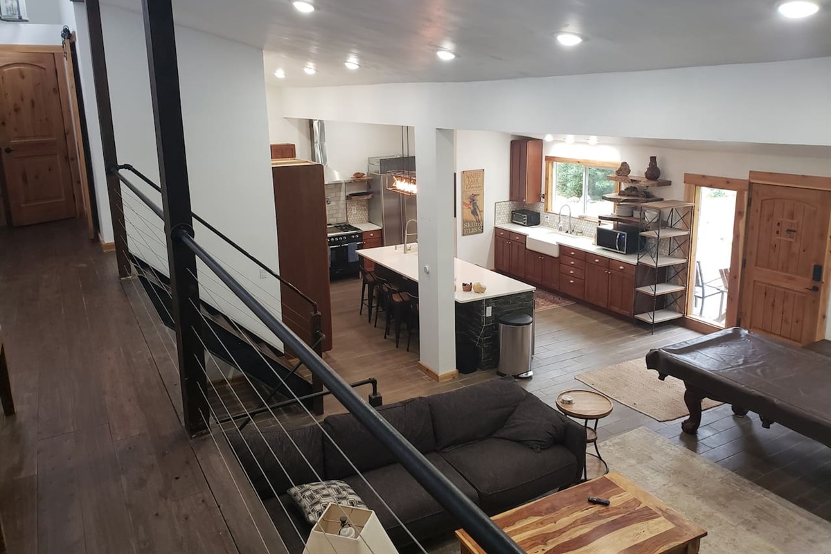 Open floor plan living room, kitchen, dining room. 2 Farmhouse style sinks. Live edge shelves. fully stocked kitchen. 