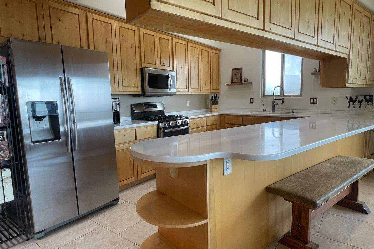 The large peninsula adds extra workspace and casual seating to this inviting kitchen.
