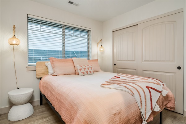 Relaxation has never been easier in our cozy beach themed room with rattan lighting, quality linens, comfortable hybrid zinus mattress, beach themed art on the walls, 32" Roku TV, modern nightstands and luggage racks. #cozy