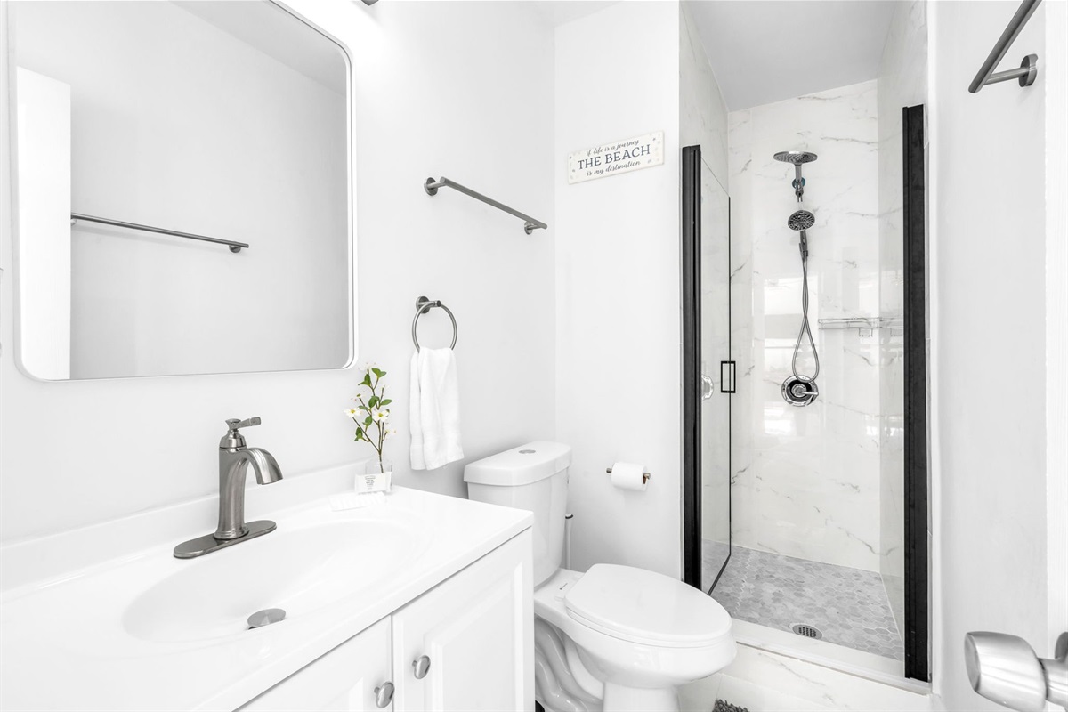 Bright, newly constructed ensuite bathroom attached to Bedroom 4, offering a sleek walk-in shower, updated fixtures, and a clean contemporary design.