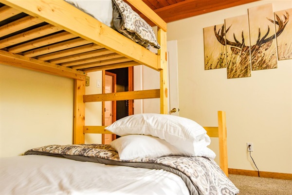 A bunk twin over a queen bed is in THE BUCK’S CORNER bedroom.