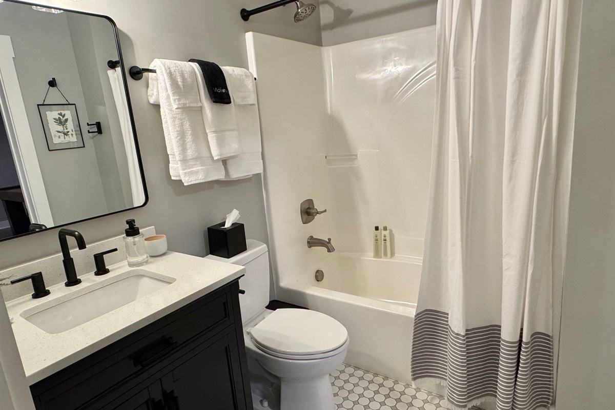 Full bath located downstairs, accessible from the bunk room and the entertainment/game room.