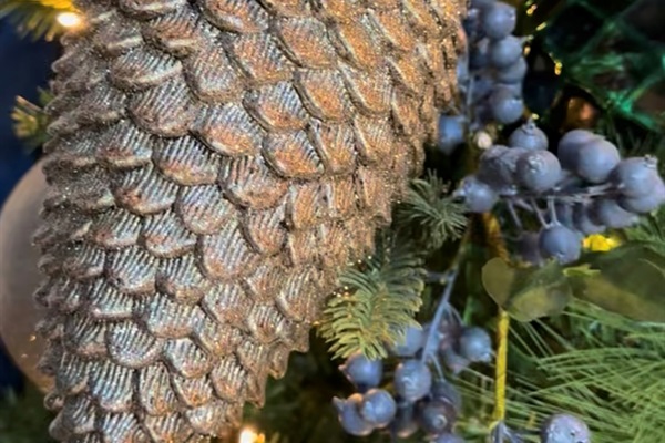 Rustic holiday décor—plaid ribbon, golden bells, and greenery—bringing festive charm to our Broken Bow cabin. 🌲✨