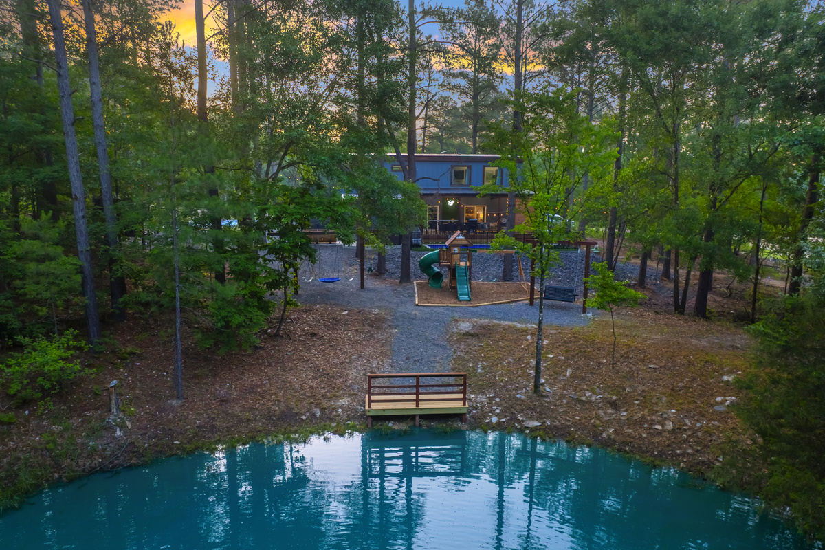 Wake up to this. A peaceful pond surrounded by towering pines with sunlight filtering through the trees. Sip coffee pondside on the swing, fish from the dock & come back for sunset.