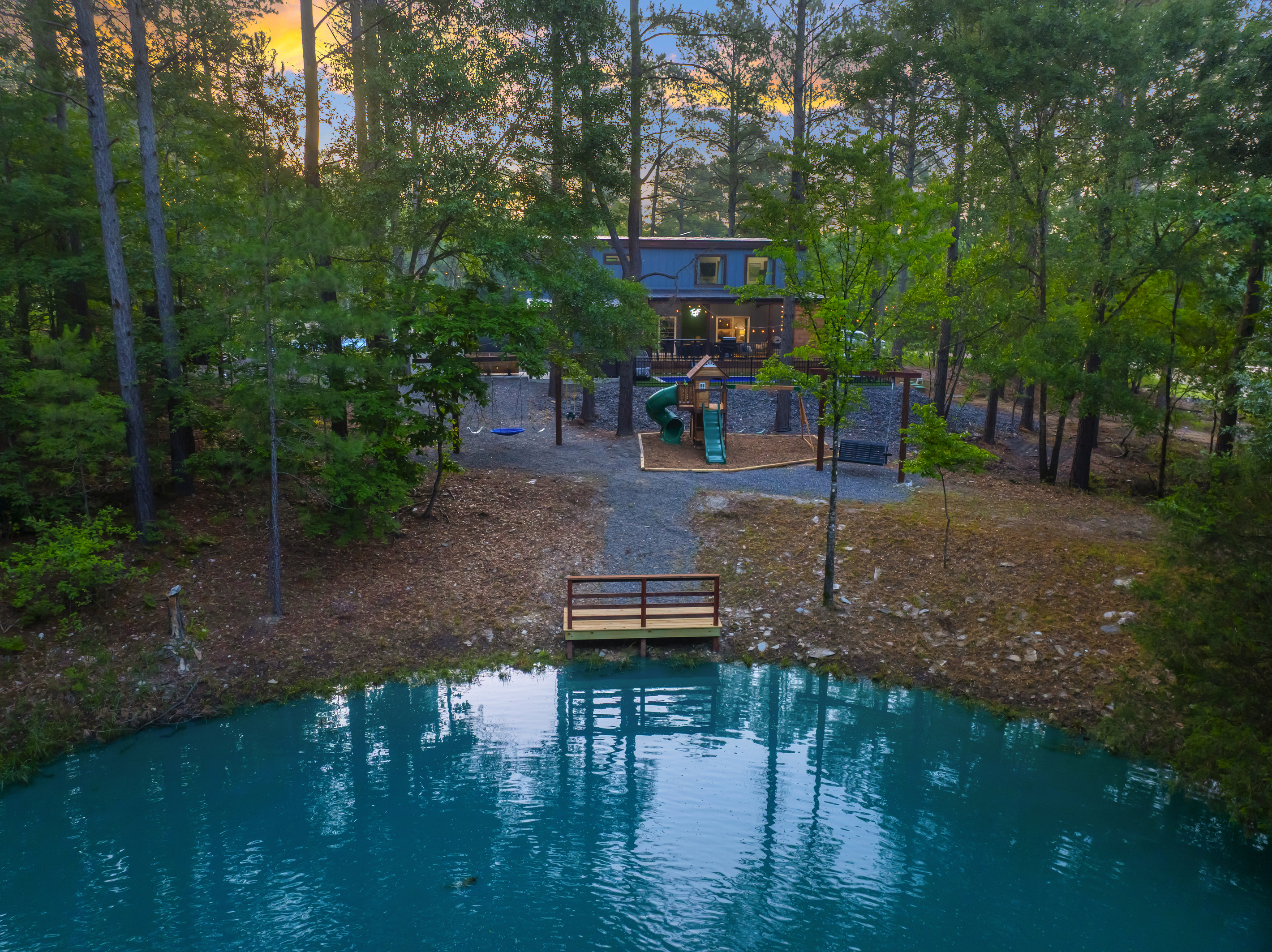 Wake up to this. A peaceful pond surrounded by towering pines with sunlight filtering through the trees. Sip coffee pondside on the swing, fish from the dock & come back for sunset.