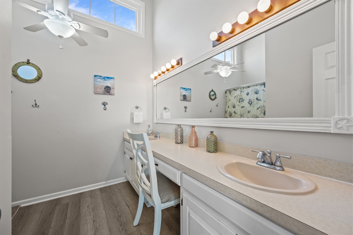 Ensuite master bathroom with a double vanity and dedicated vanity seating area for getting ready